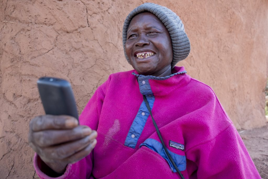 A CVA recipient checks the receipt of a cash transfer on her mobile account.